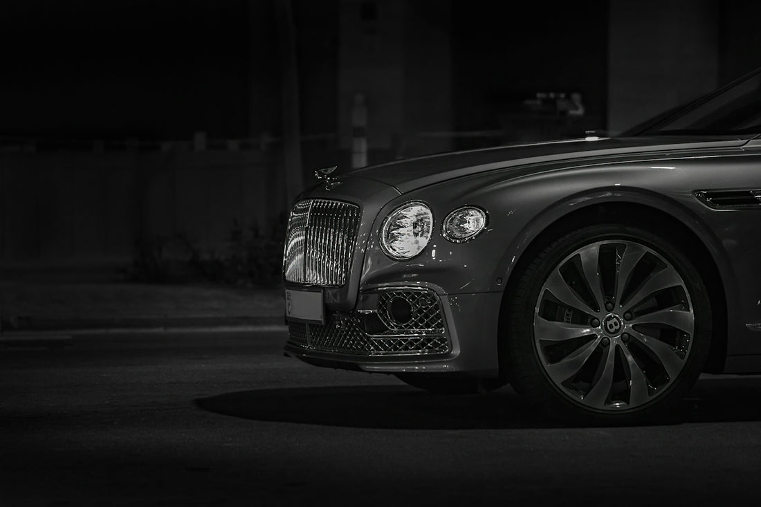 Front view of a luxury car with a chrome grille at night